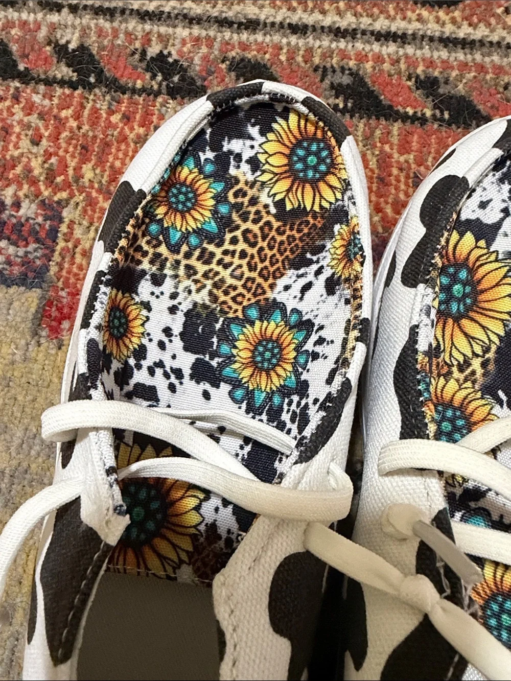 Women’s White & Black Cow Print Slip-On Sneakers with Sunflower Lining